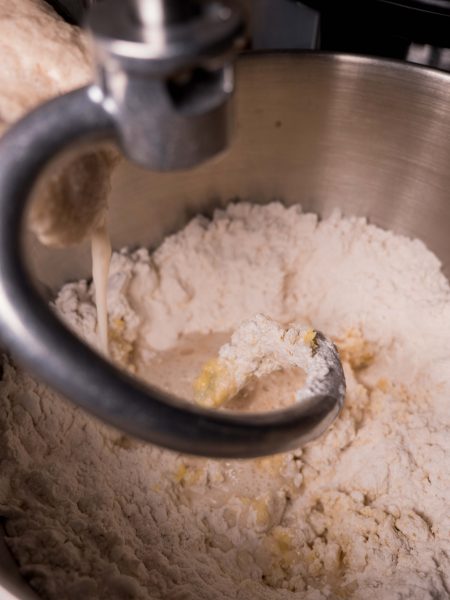 adding yeast mixture into dough mix
